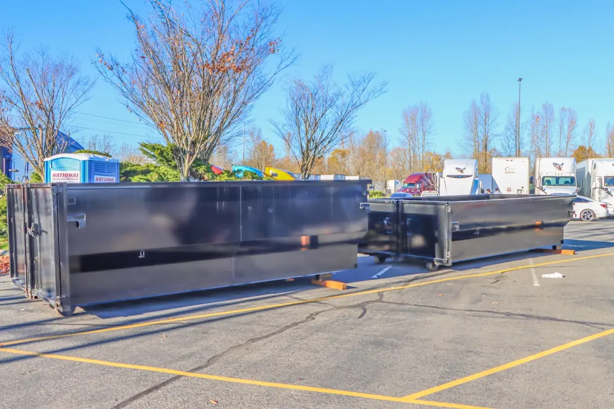 Professional dumpster rental service with roll-off container on residential driveway in Townsend
